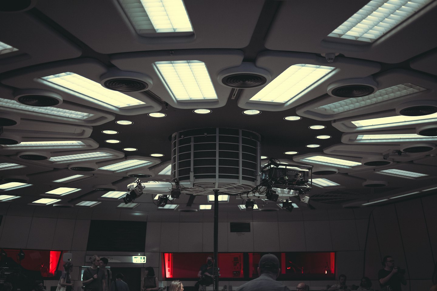 Moderne Decke mit Einbaustrahlern und zentraler Hängekonstruktion.